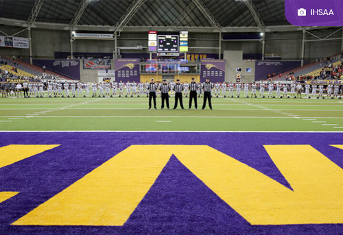 Football players and refs at the UNI Dome